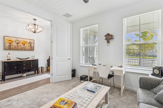 sitting room featuring a notable chandelier and carpet floors