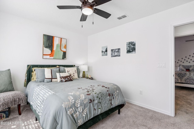 bedroom with light carpet and ceiling fan