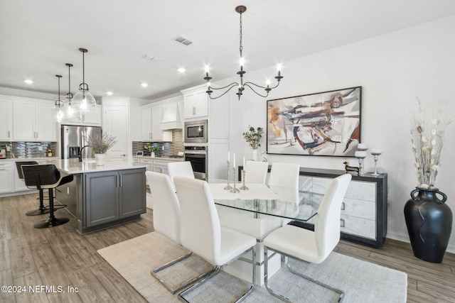 dining space featuring dark hardwood / wood-style floors and a chandelier