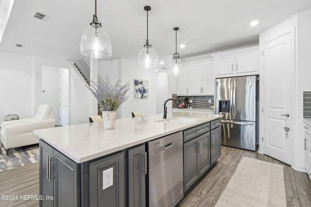 kitchen featuring gray cabinets, light wood-type flooring, sink, appliances with stainless steel finishes, and white cabinets