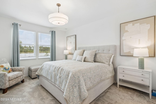 bedroom featuring light colored carpet