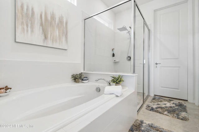 bathroom featuring plus walk in shower and tile patterned flooring