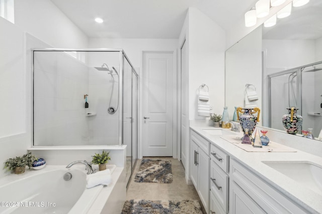 bathroom with vanity and shower with separate bathtub