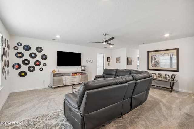 carpeted living room featuring ceiling fan