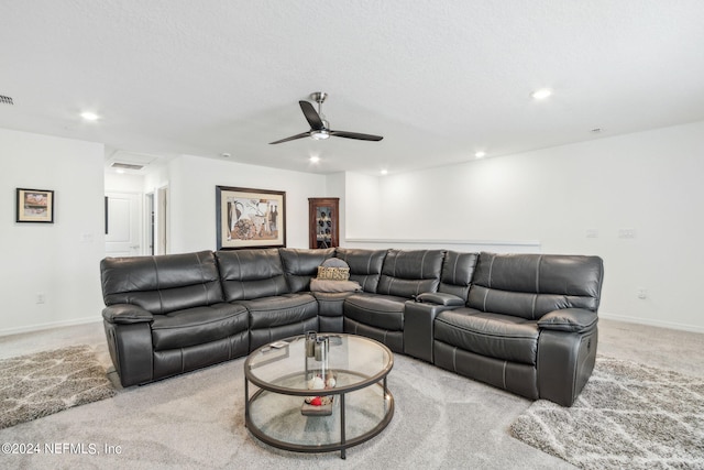 living room with light carpet, a textured ceiling, and ceiling fan