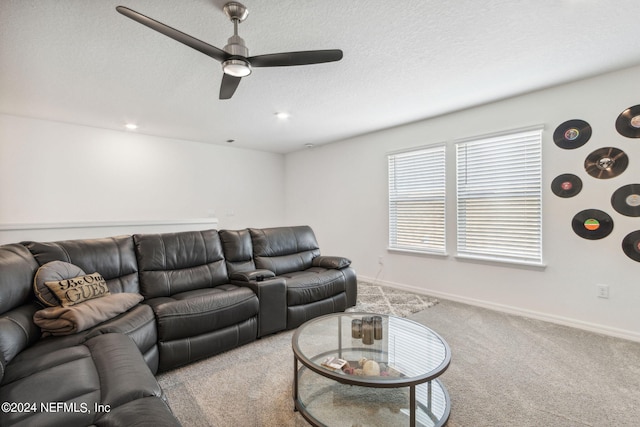 living room with light colored carpet, ceiling fan, and a textured ceiling