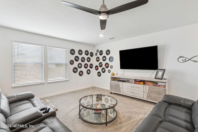 carpeted living room with a textured ceiling and ceiling fan