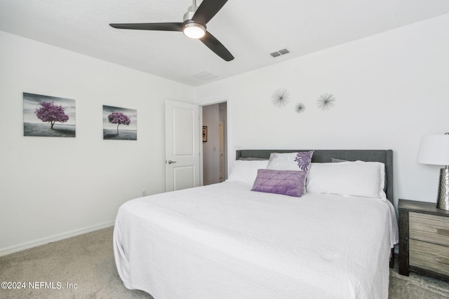 bedroom with ceiling fan and light carpet