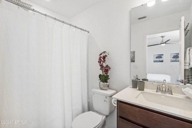 bathroom featuring vanity, toilet, and ceiling fan