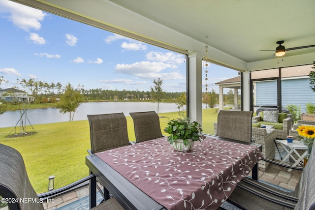 exterior space featuring ceiling fan and a water view