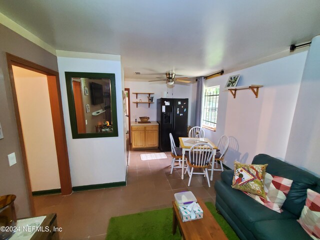 living room featuring tile patterned flooring and ceiling fan