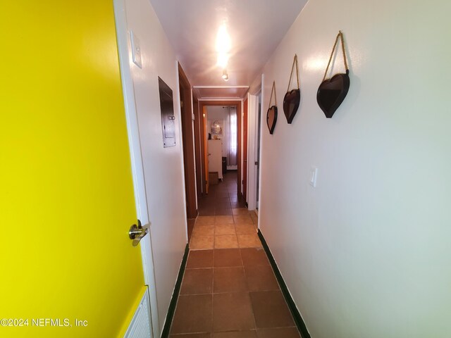 hall featuring dark tile patterned floors