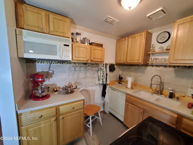 kitchen featuring backsplash, white appliances, light brown cabinets, and sink