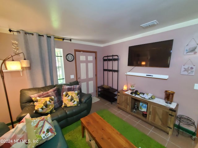 living room featuring crown molding and tile patterned floors