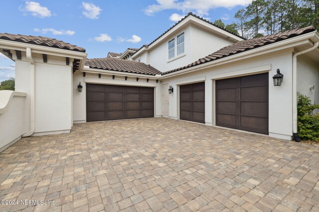 mediterranean / spanish-style home with a garage