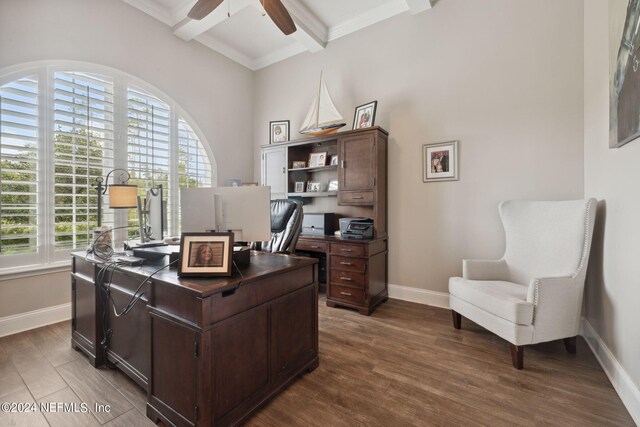 office space featuring light hardwood / wood-style flooring, ceiling fan, ornamental molding, and beam ceiling