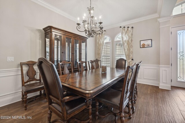 dining space featuring crown molding, a wealth of natural light, and dark hardwood / wood-style floors