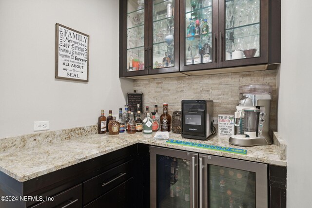 bar with beverage cooler and tasteful backsplash