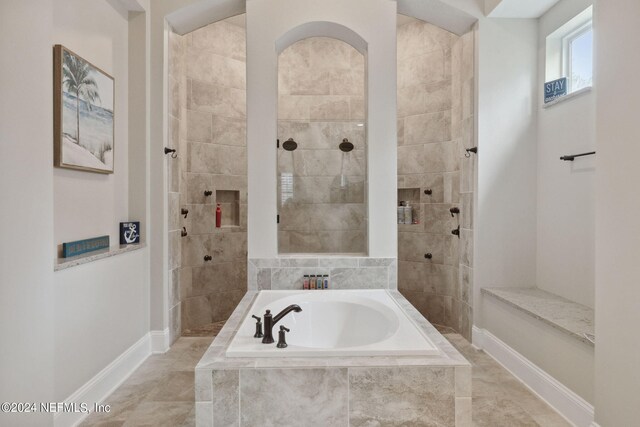 bathroom featuring separate shower and tub