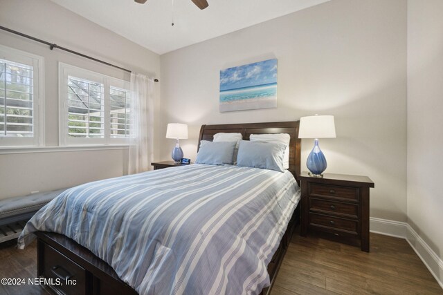 bedroom with ceiling fan and dark hardwood / wood-style floors