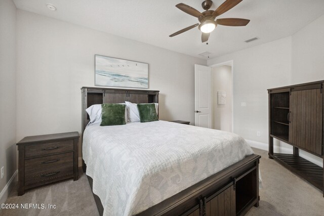 bedroom with light colored carpet and ceiling fan