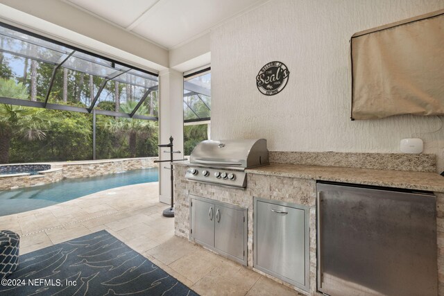 view of patio featuring grilling area, a lanai, and an outdoor kitchen