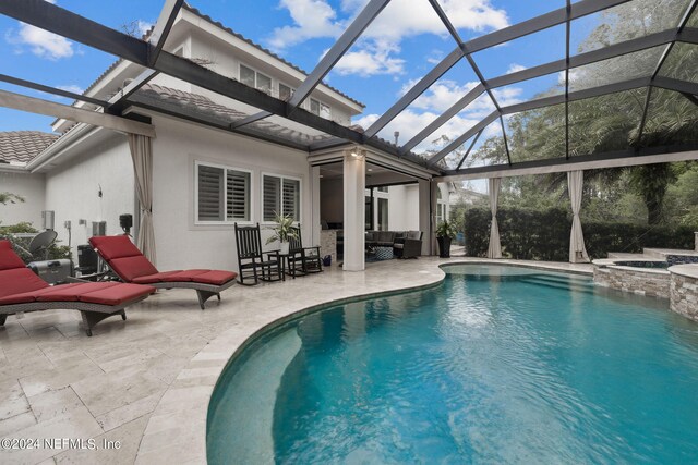 view of swimming pool with a lanai, an in ground hot tub, and a patio