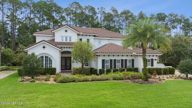 mediterranean / spanish house with a front yard