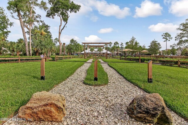 view of property's community with a lawn