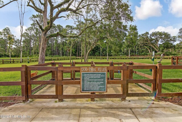 view of gate with a yard