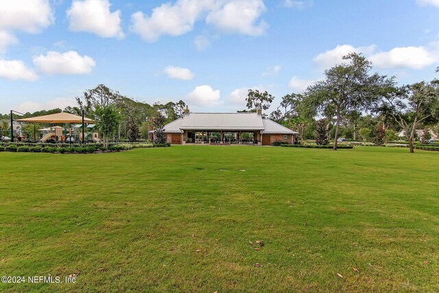 view of property's community with a lawn and a gazebo