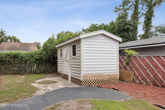 view of shed with fence