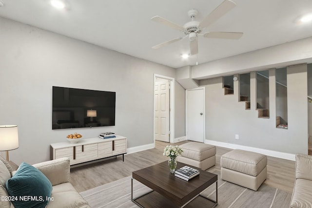 living room with ceiling fan and light hardwood / wood-style flooring