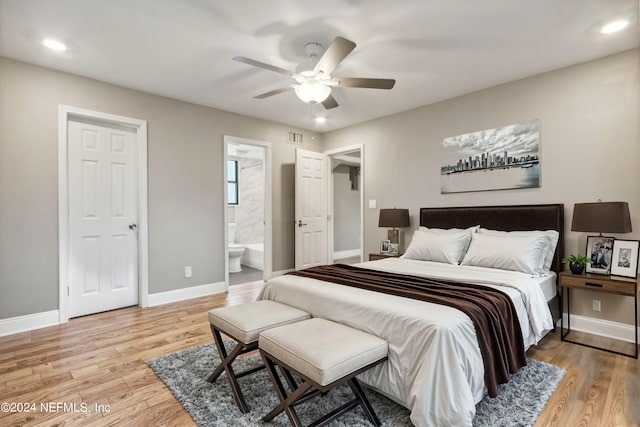 bedroom with light hardwood / wood-style floors, ensuite bath, and ceiling fan