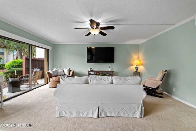 living room featuring a textured ceiling, light colored carpet, ceiling fan, and ornamental molding