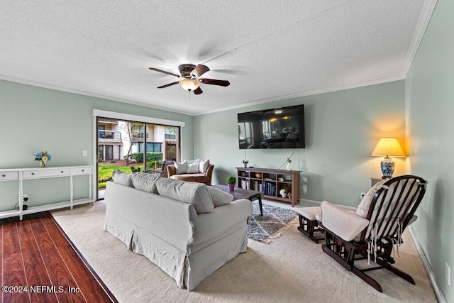 living room with a textured ceiling, ceiling fan, and crown molding