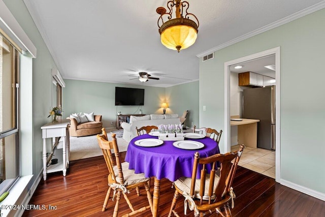 dining area with ceiling fan, wood-type flooring, and ornamental molding