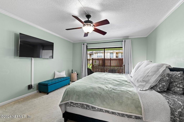 carpeted bedroom with a textured ceiling, ceiling fan, and crown molding