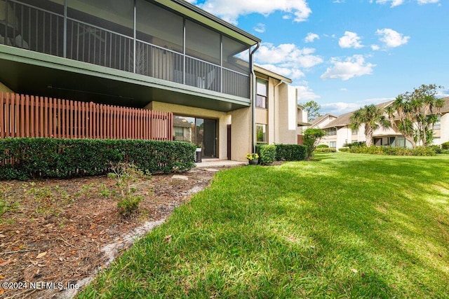 rear view of property with a yard