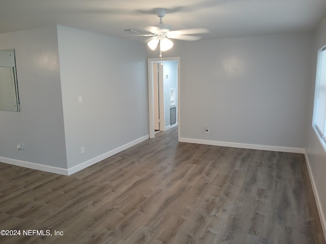 spare room featuring ceiling fan and dark hardwood / wood-style floors