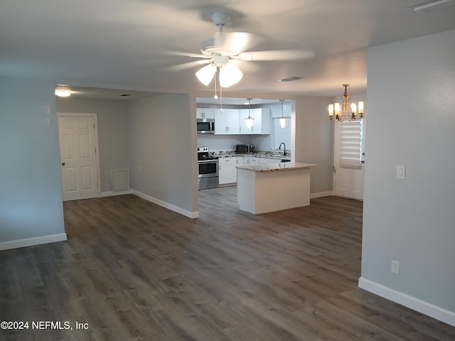 kitchen with ceiling fan with notable chandelier, stainless steel appliances, dark hardwood / wood-style flooring, white cabinetry, and kitchen peninsula