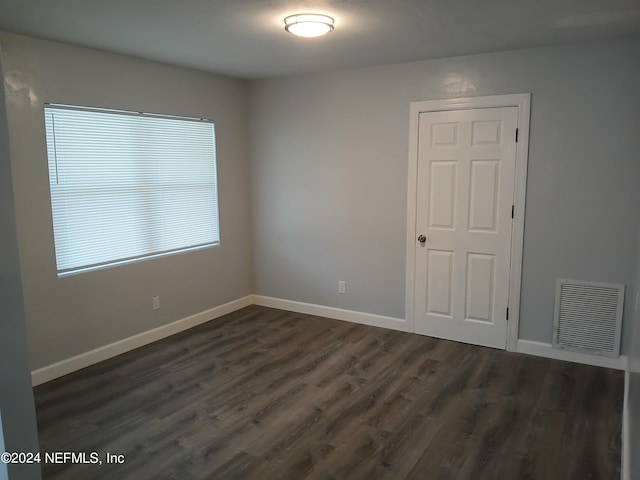 spare room featuring dark hardwood / wood-style floors