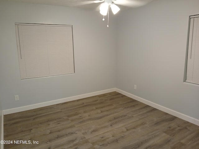 spare room with ceiling fan and dark hardwood / wood-style flooring