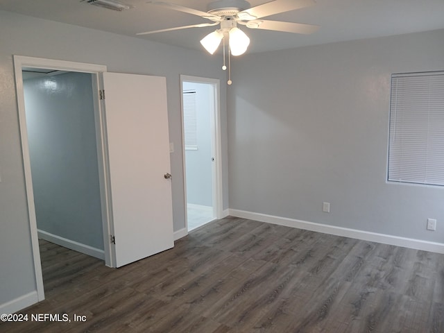 unfurnished bedroom with dark hardwood / wood-style flooring and ceiling fan