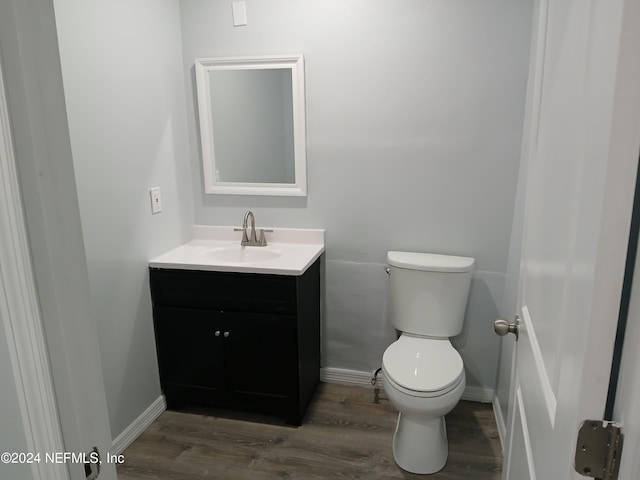 bathroom featuring hardwood / wood-style floors, toilet, and vanity