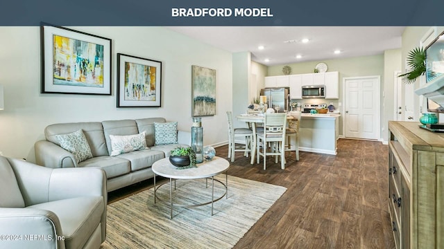 living area featuring baseboards, dark wood-type flooring, and recessed lighting