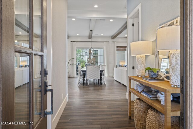 hall with dark wood-type flooring and beamed ceiling