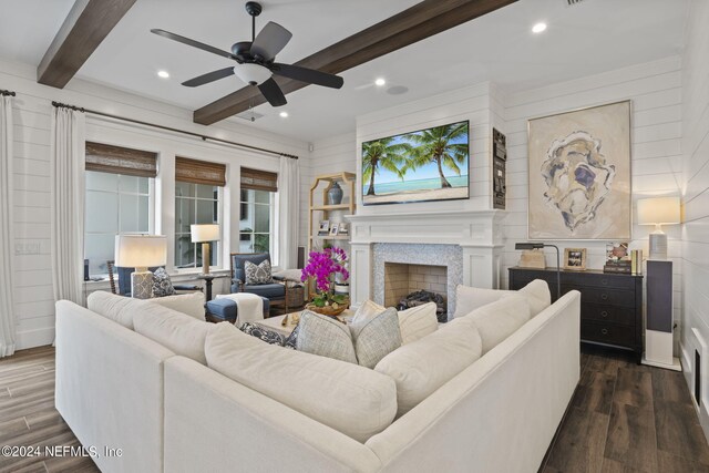 living room with ceiling fan, beam ceiling, and dark hardwood / wood-style flooring