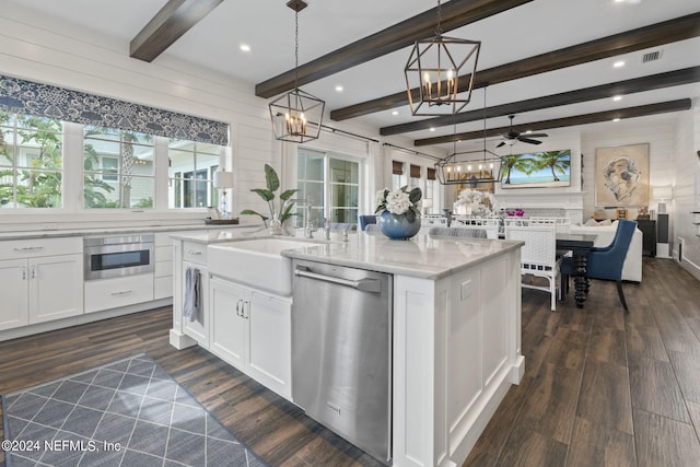 kitchen featuring ceiling fan with notable chandelier, beamed ceiling, stainless steel appliances, and hanging light fixtures