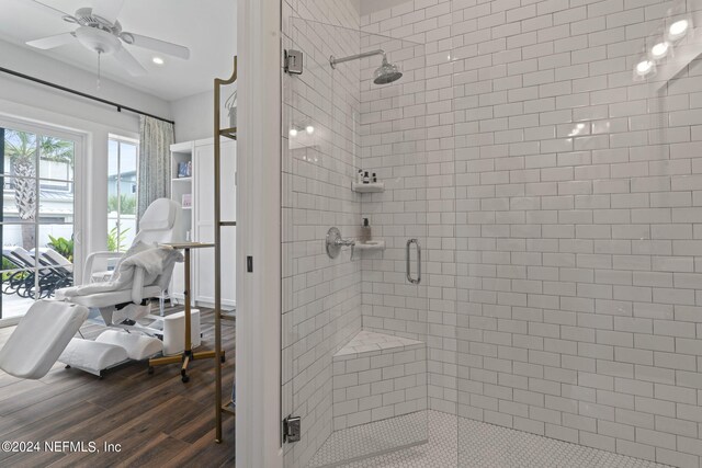 bathroom with an enclosed shower, ceiling fan, and hardwood / wood-style flooring